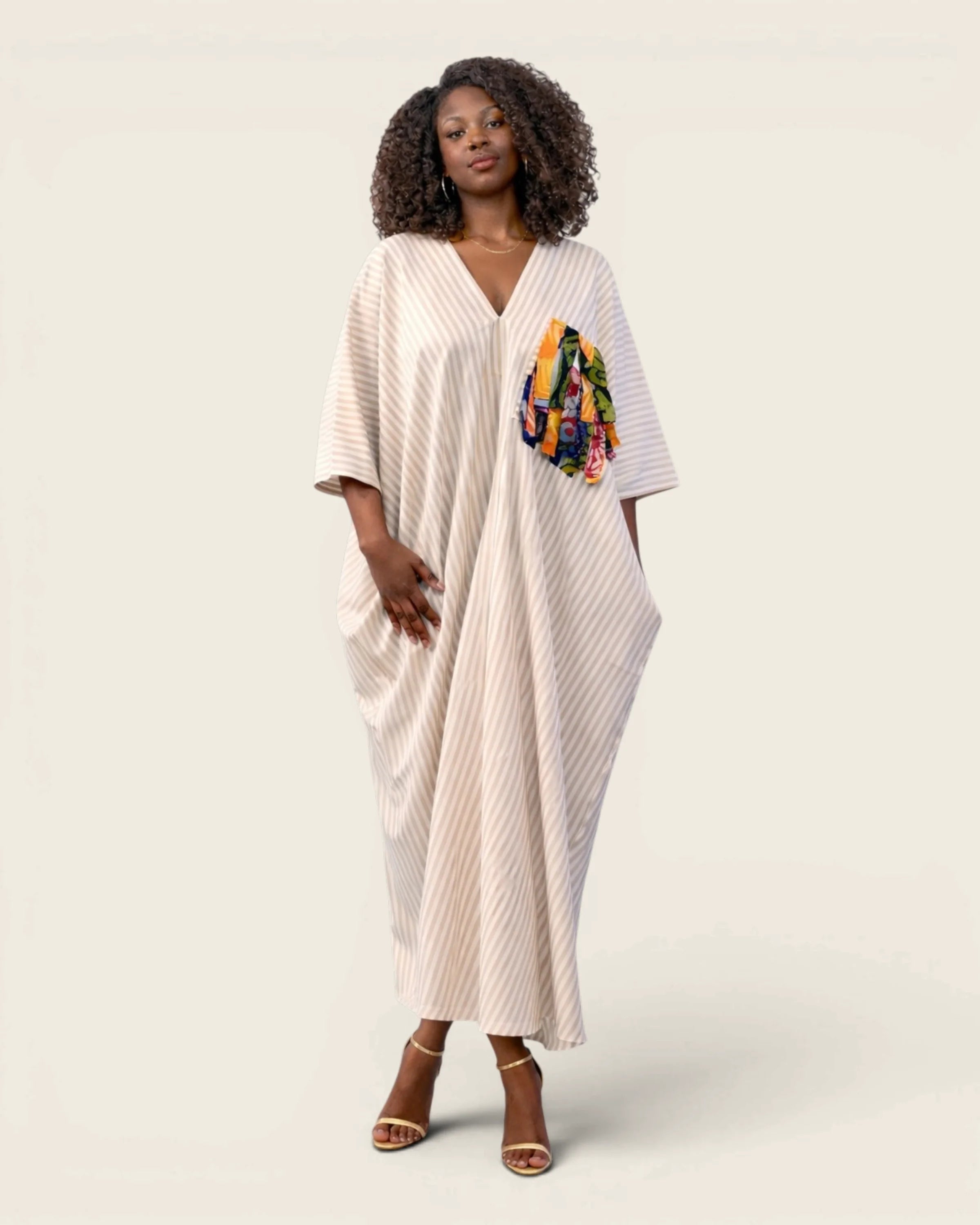 The Amari Adire kaftan dress, front view, hand-dyed ivory striped cloth
