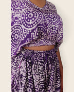 Simi Amethyst Medallion — hand-dyed Adire fabric detail, lilac dotted medallions on deep violet, close-up of the crop top and smocked waist, L'atelier KaAy