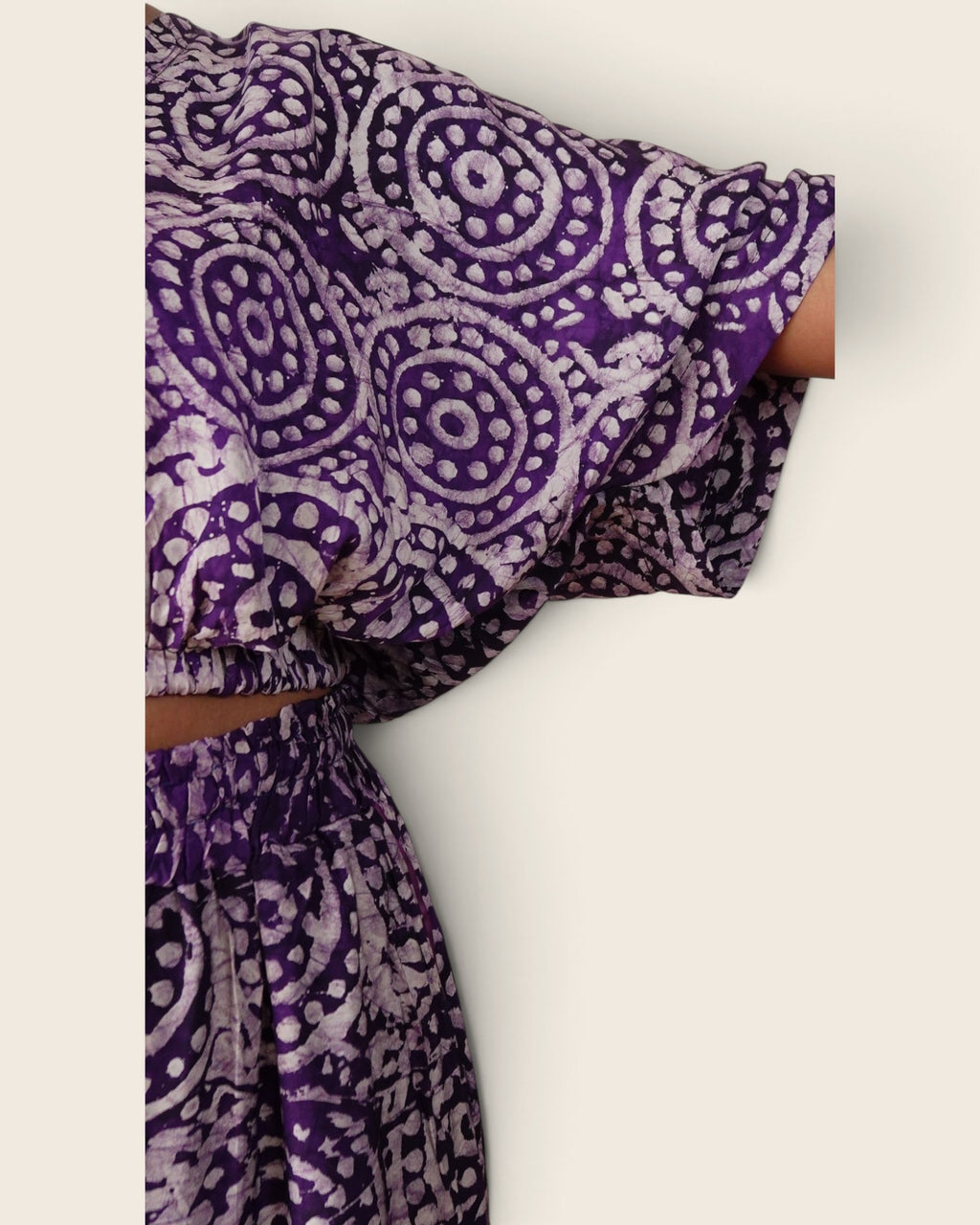 Simi Amethyst Medallion — hand-dyed Adire fabric detail, lilac dotted medallions on deep violet, close-up of the batwing sleeve, L'atelier KaAy