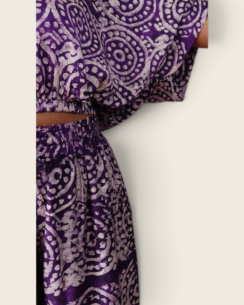 Simi Amethyst Medallion — hand-dyed Adire fabric detail, lilac dotted medallions on deep violet, close-up of the sleeve and waistband, L'atelier KaAy