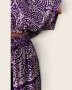 Simi Amethyst Medallion — hand-dyed Adire fabric detail, lilac dotted medallions on deep violet, close-up of the sleeve and waistband, L'atelier KaAy