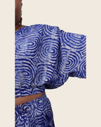 Simi Lapis Ripple — hand-dyed Adire fabric detail, silvery concentric rings on lapis blue, close-up of the batwing sleeve, L'atelier KaAy