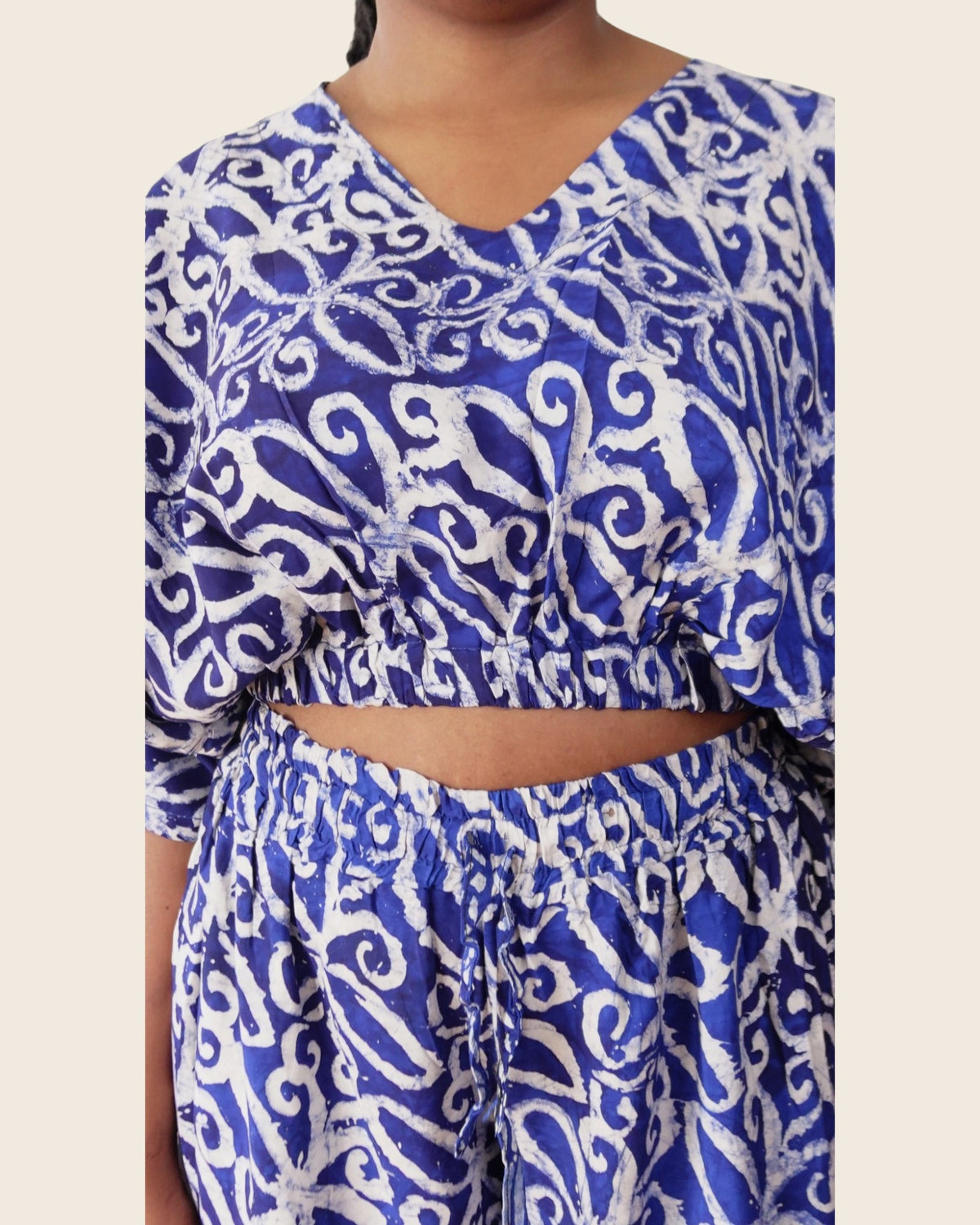 Simi Delft Scroll — hand-dyed Adire fabric detail, crisp white scrolls on cobalt, close-up of the V-neck crop top and waistband, L'atelier KaAy