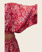 Simi Garnet Swirl — hand-dyed Adire fabric detail, blush swirls with slate-blue touches on garnet red, close-up of the batwing sleeve, L'atelier KaAy