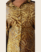 Adunni Golden Bark — hand-dyed Adire fabric detail, gold and soft grey medallions on bark brown, close-up of the collar and buttons, L'atelier KaAy