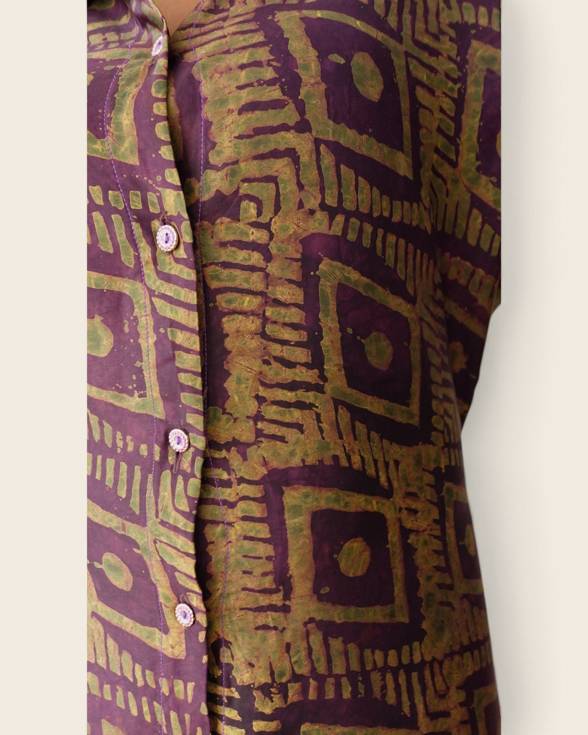 Adunni Fig Tile — hand-dyed Adire fabric detail, olive-gold squares on deep fig purple, close-up of the buttons, L'atelier KaAy