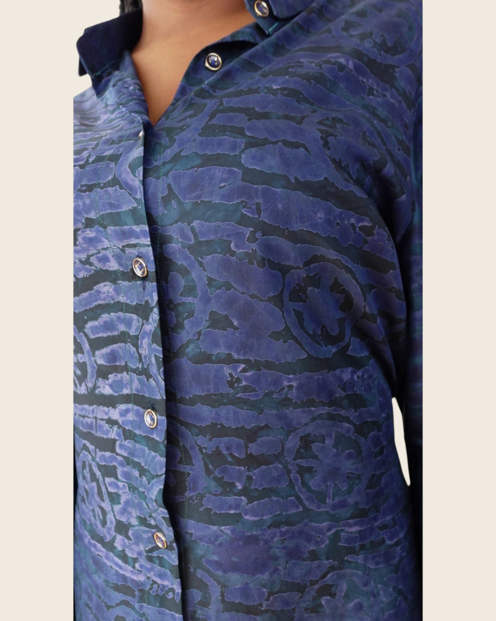 Adunni Midnight Tide — hand-dyed Adire fabric detail, dark teal and indigo motifs on midnight navy, close-up of the collar and buttons, L'atelier KaAy