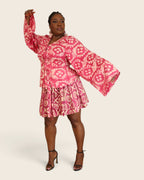 Aïna Hibiscus Pink — african print skirt set in hand-dyed Adire, front view, one bell sleeve raised, L'atelier KaAy