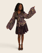 Aïna Plum Moss — african print skirt set in hand-dyed Adire, front view, one bell sleeve raised, L'atelier KaAy