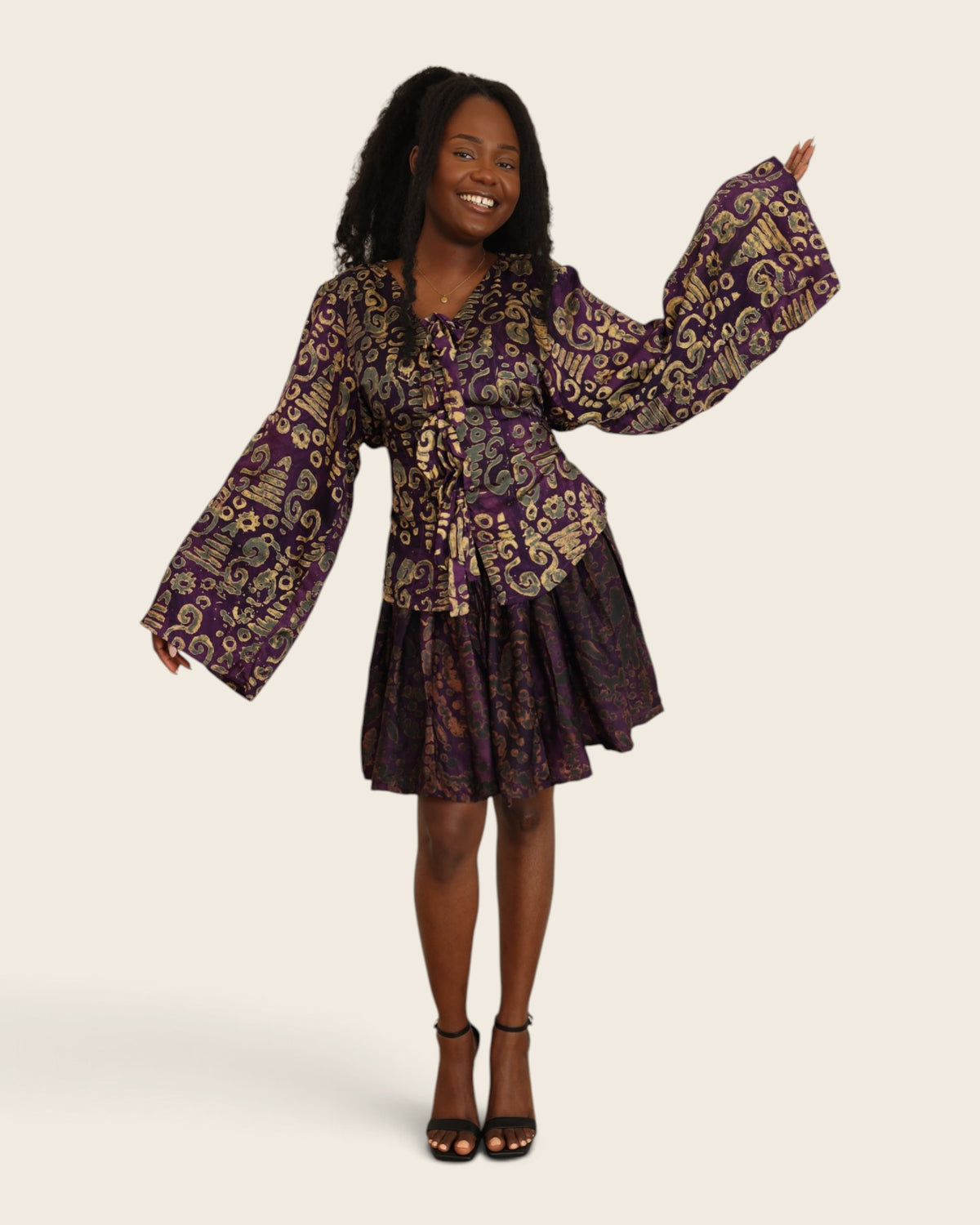 Aïna Plum Moss — african print skirt set in hand-dyed Adire, front view, one bell sleeve raised, L'atelier KaAy