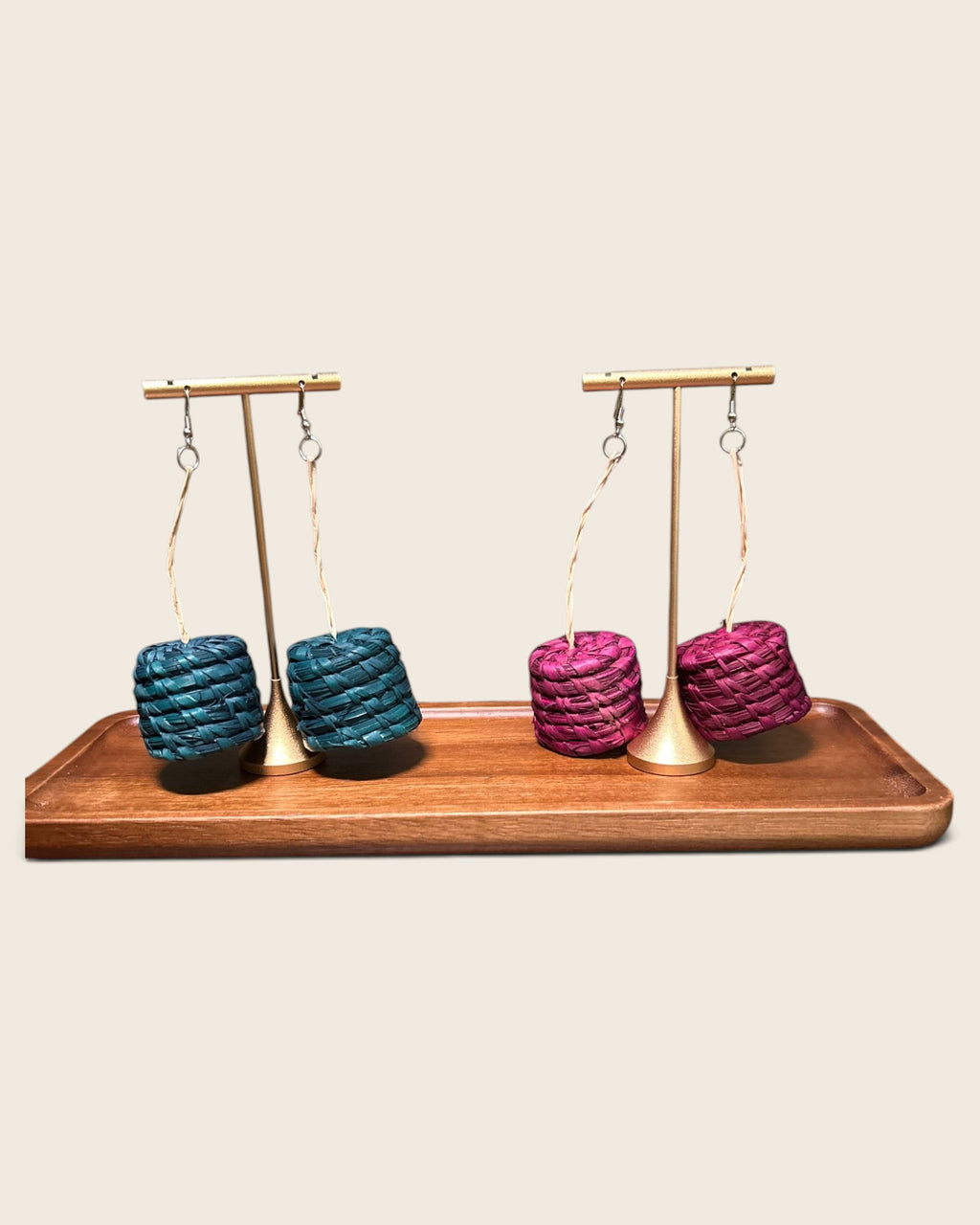 Abeni woven raffia drum earrings in Malachite Teal and Raspberry Pink on gold stands, hand-woven in Nigeria