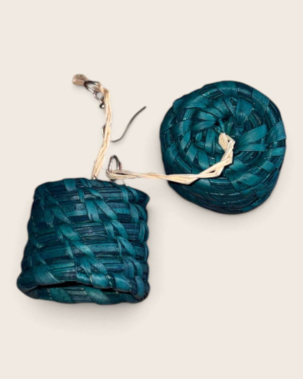 Close-up of the coiled base and open top on Malachite Teal raffia drum earrings, L'atelier KaAy