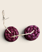 Top view of the spiral coil on a pair of Raspberry Pink raffia drum earrings, L'atelier KaAy