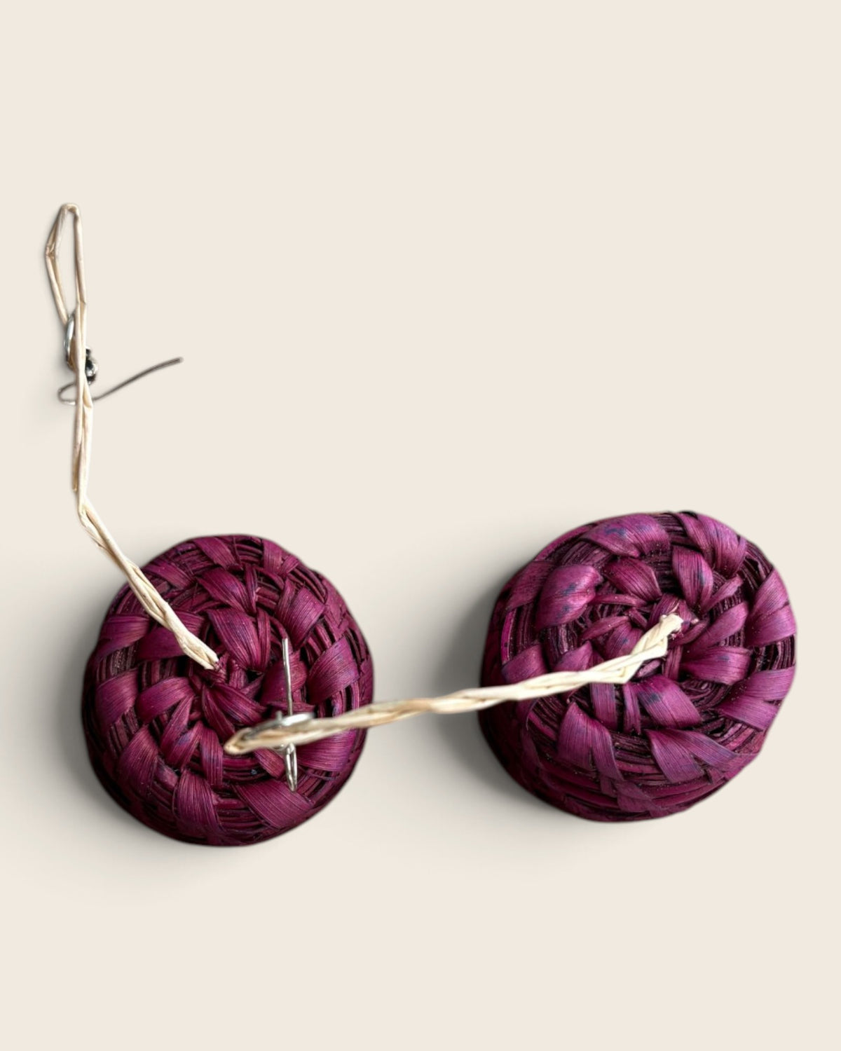 Top view of the spiral coil on a pair of Raspberry Pink raffia drum earrings, L'atelier KaAy