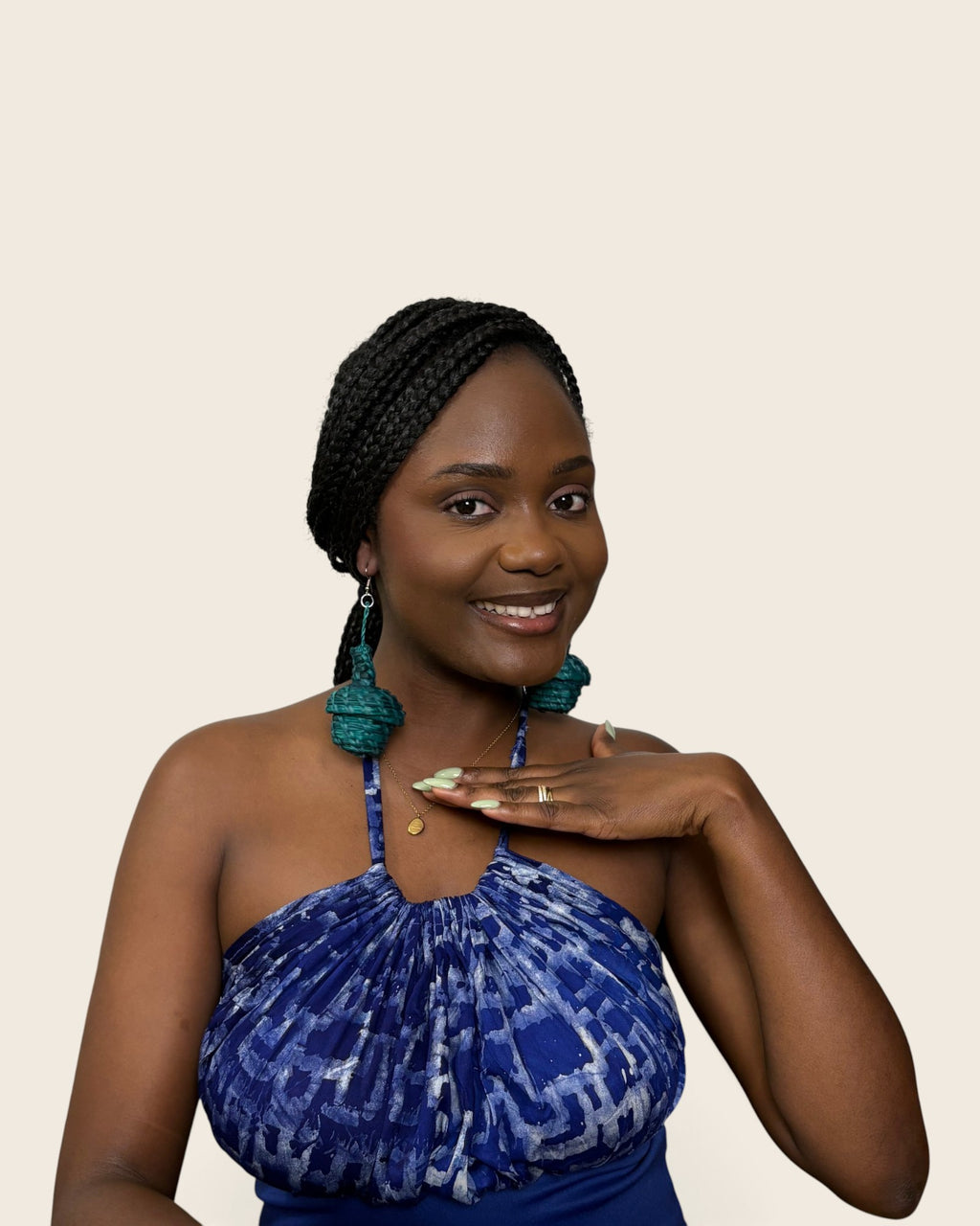 Deep teal tiered raffia basket drop earrings worn with a blue Adire halter top, L'atelier KaAy