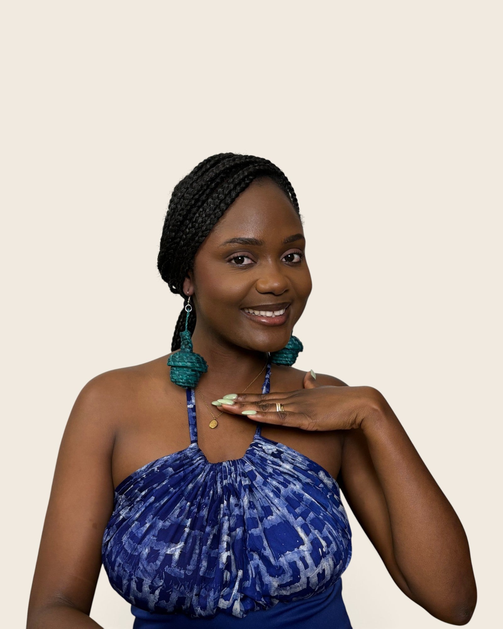 Deep teal tiered raffia basket drop earrings worn with a blue Adire halter top, L'atelier KaAy