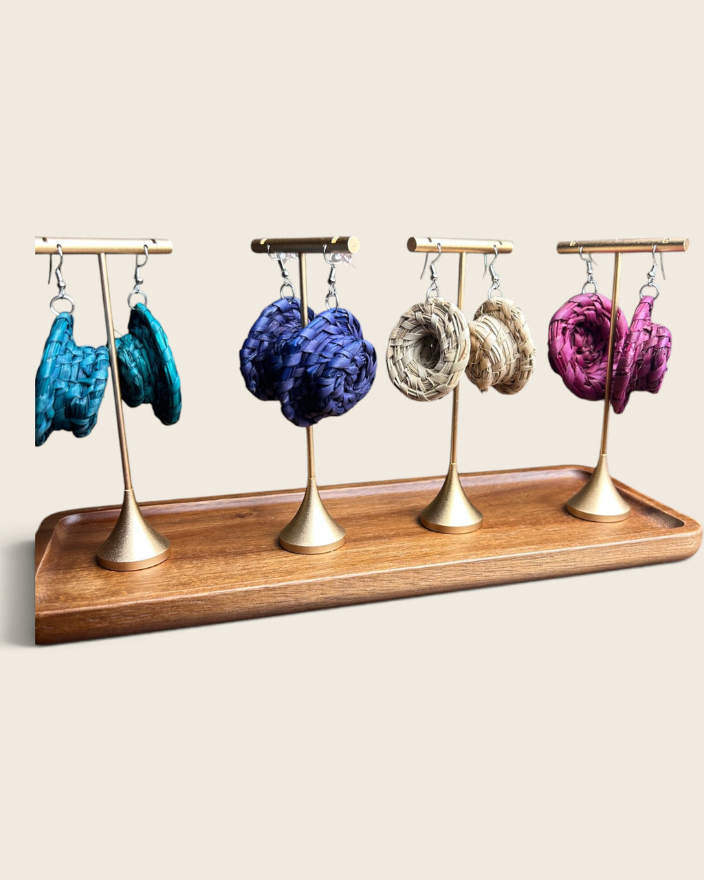Nala woven halo raffia earrings in Natural, Deep Teal, Royal Violet and Raspberry Pink on gold stands, hand-woven in Nigeria