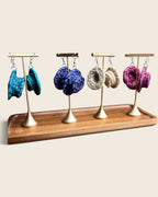 Nala woven halo raffia earrings in Natural, Deep Teal, Royal Violet and Raspberry Pink on gold stands, hand-woven in Nigeria