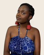 Cinnabar Red raffia bell earring seen in profile, showing its coiled dome, L'atelier KaAy