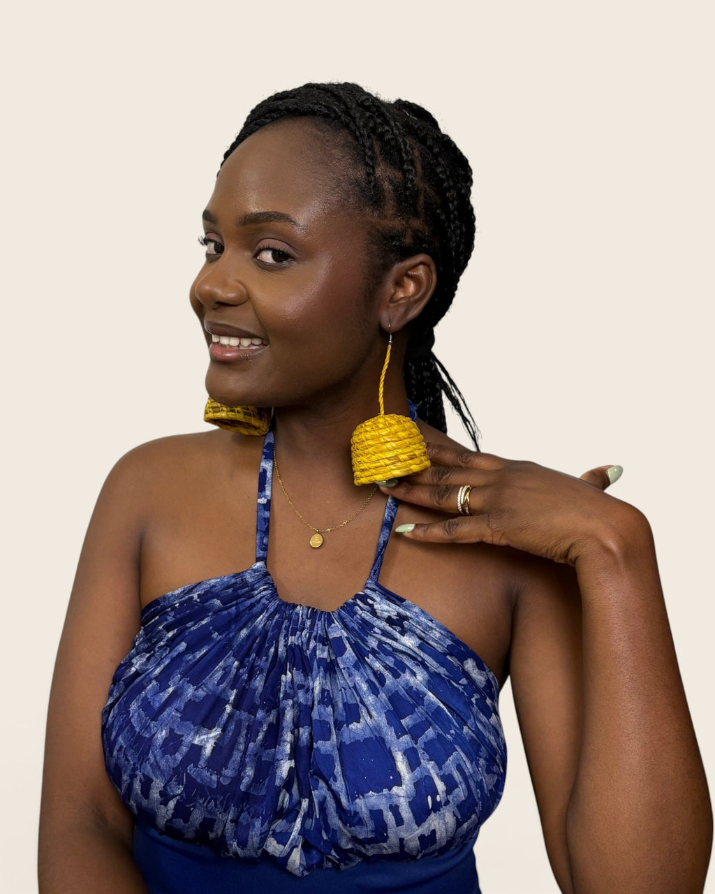 Side profile of lightweight saffron gold coiled raffia bell earrings on a fine braided cord, L'atelier KaAy