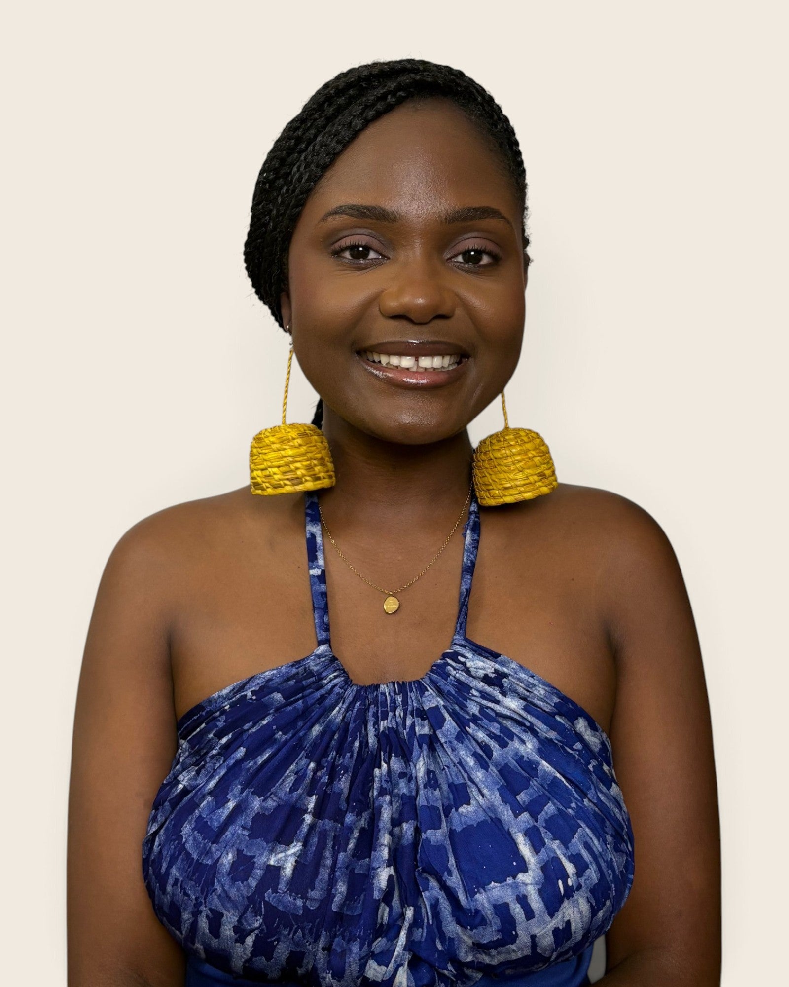 Model wearing Sade saffron gold hand-woven raffia bell statement earrings, L'atelier KaAy