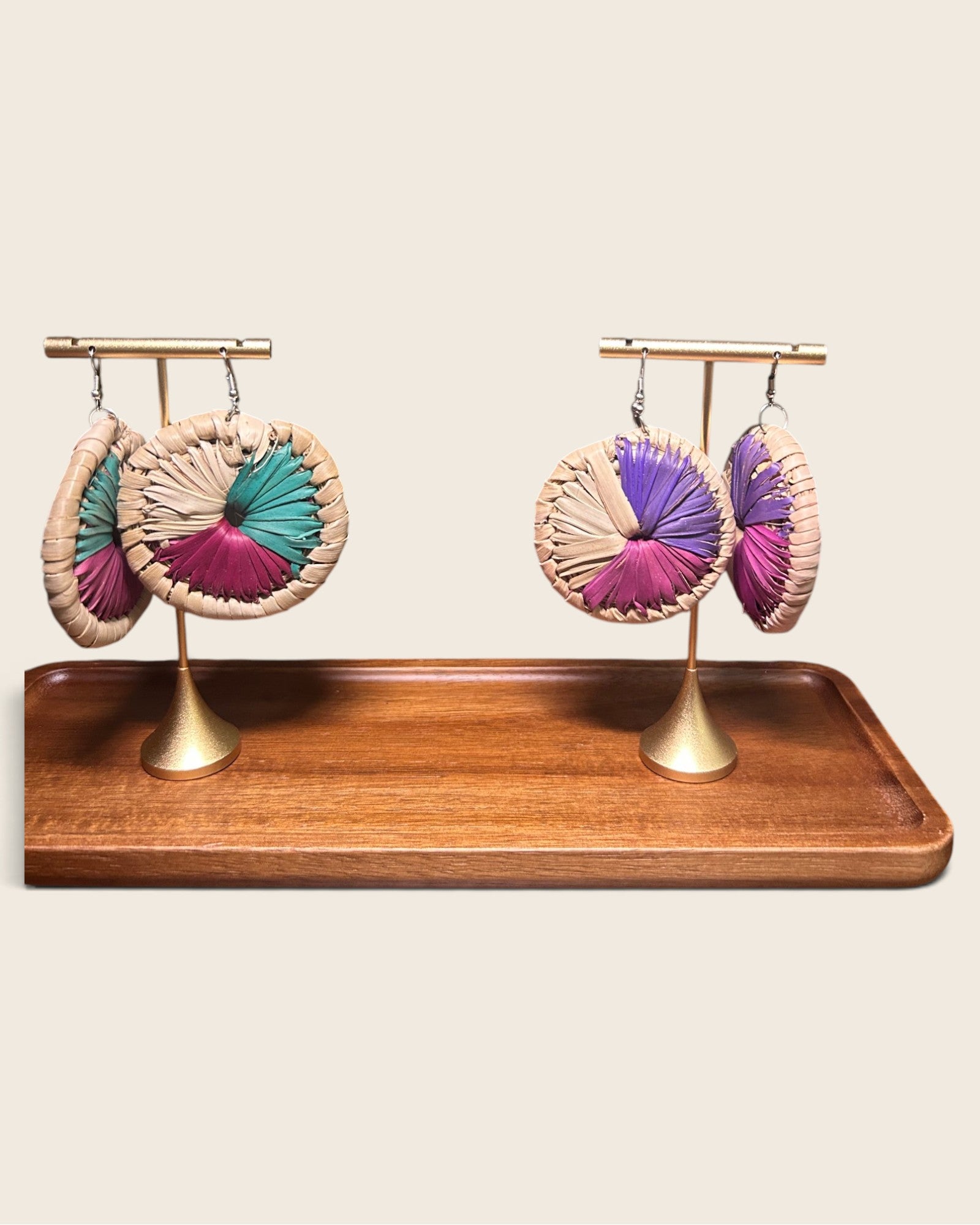 Sanaa oversized raffia disc earrings in Malachite Teal and Royal Violet on gold stands, hand-woven in Nigeria