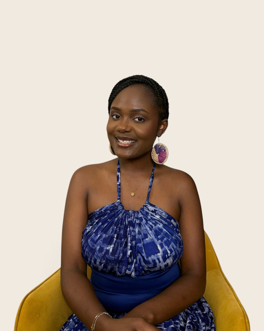 Model styling large round Royal Violet hand-dyed raffia disc earrings with an indigo Adire halter dress, L'atelier KaAy