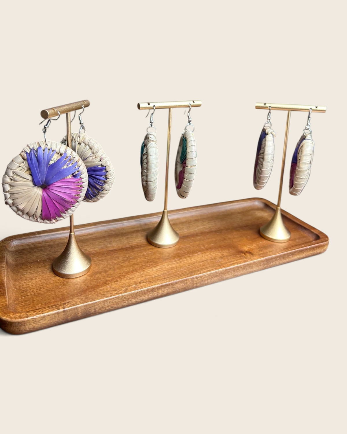 Sanaa oversized raffia disc earrings shown front, edge and three-quarter on gold stands, L'atelier KaAy