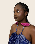 Model wearing Hibiscus Fuchsia hand-woven raffia half-moon drop statement earrings, L'atelier KaAy