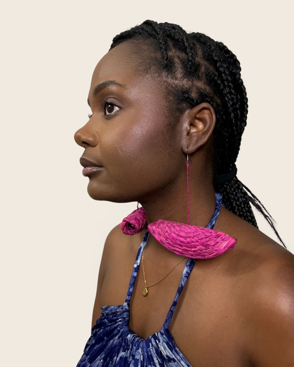 Model in profile wearing handmade Hibiscus Fuchsia raffia half-moon drop statement earrings, L'atelier KaAy