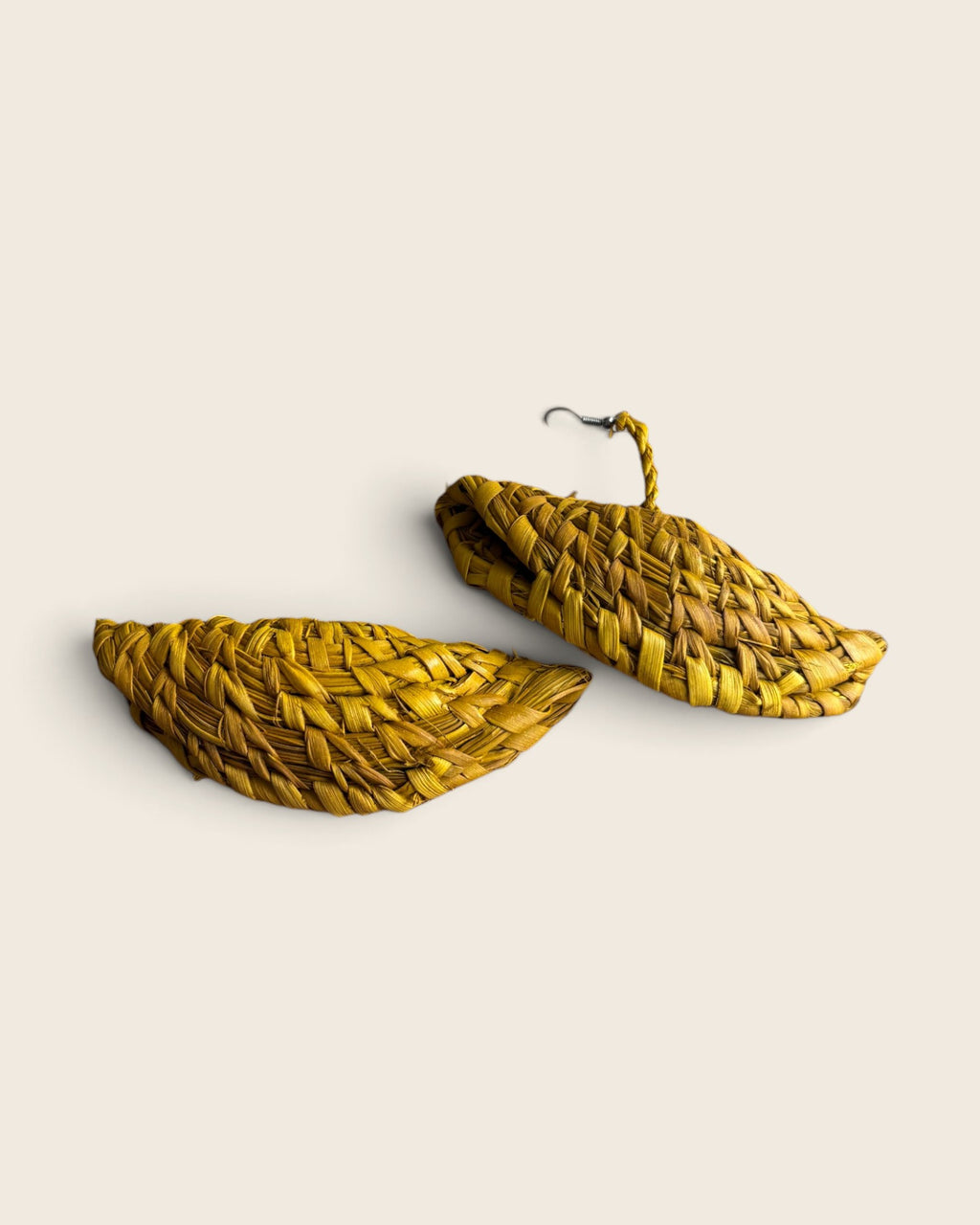Pair of Saffron Gold woven raffia half-moon drop earrings shown flat, L'atelier KaAy
